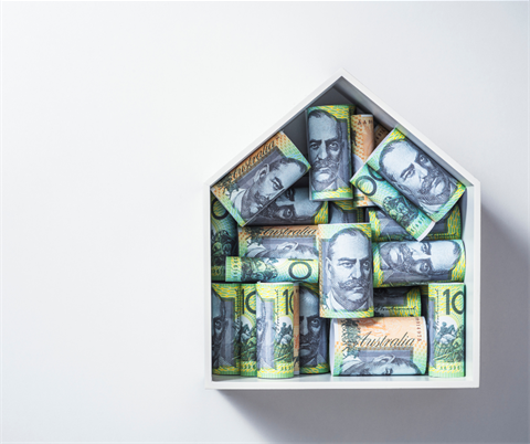 image of paper home filled with rolled bundles of $100 notes