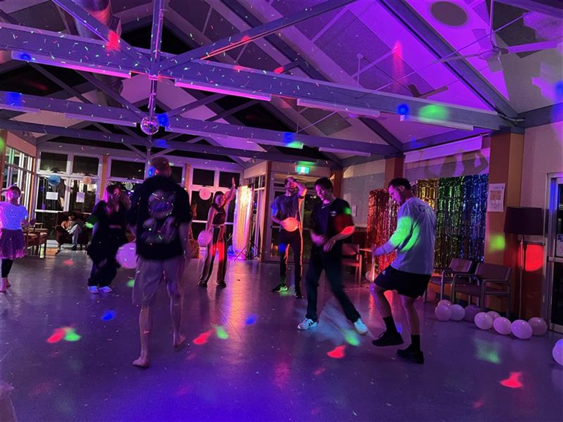 sentral dancing youth at a music gig in a hall with purple lighting